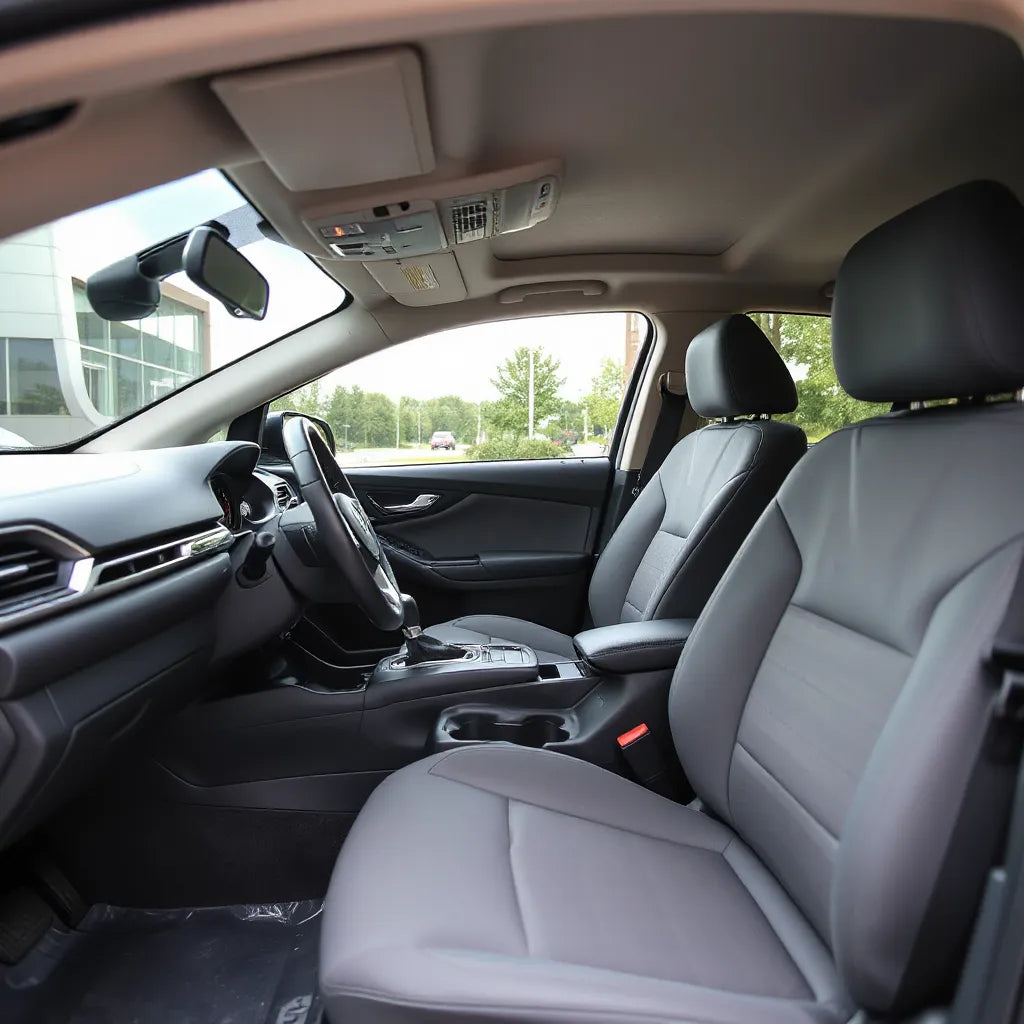 Clean car interior with protective seat covers and anti-slip floor mat in daylight